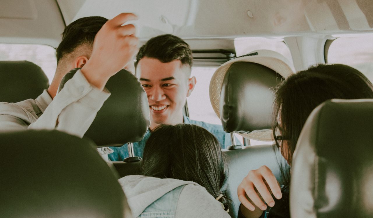 Travellers sharing a car ride together and splitting the taxi fare in Morocco