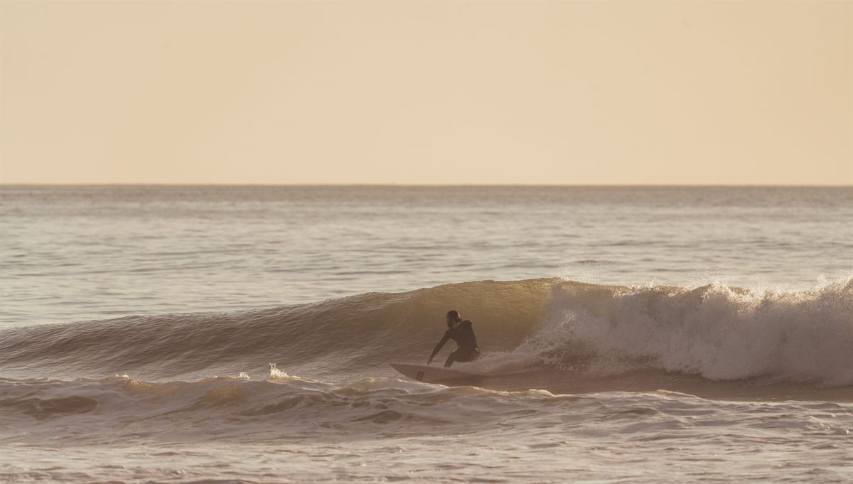 A surfer riding a long right-hand wave like the one at Imsouane Bay in Morocco