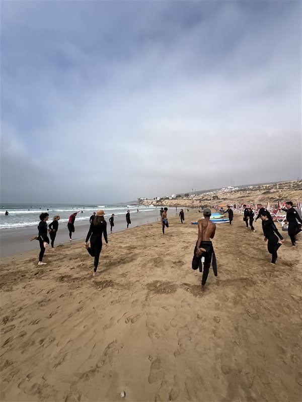 Family warming up together before a surf lesson in Taghazout