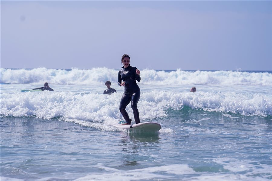 Group catching waves together during a private surf lesson in Taghazout